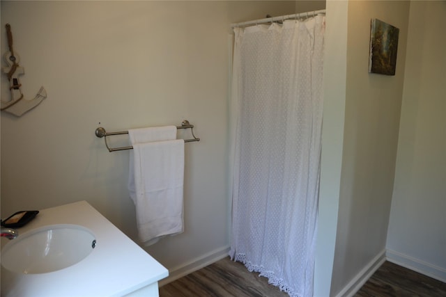 465 Creek Dr, Onalaska, TX 77360 - bathroom with wood finished floors, vanity, baseboards, and a shower with curtain