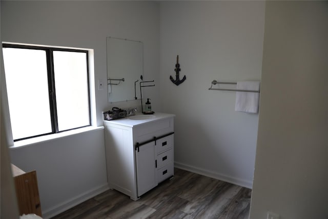 465 Creek Dr, Onalaska, TX 77360 - laundry room with a sink, wood finished floors, and baseboards