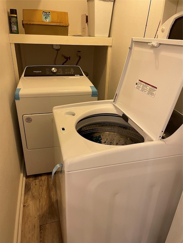 465 Creek Dr, Onalaska, TX 77360 - laundry area with independent washer and dryer and wood finished floors
