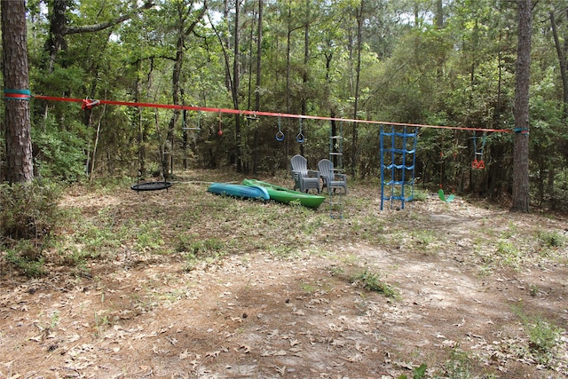 465 Creek Dr, Onalaska, TX 77360 - view of playground featuring a forest view