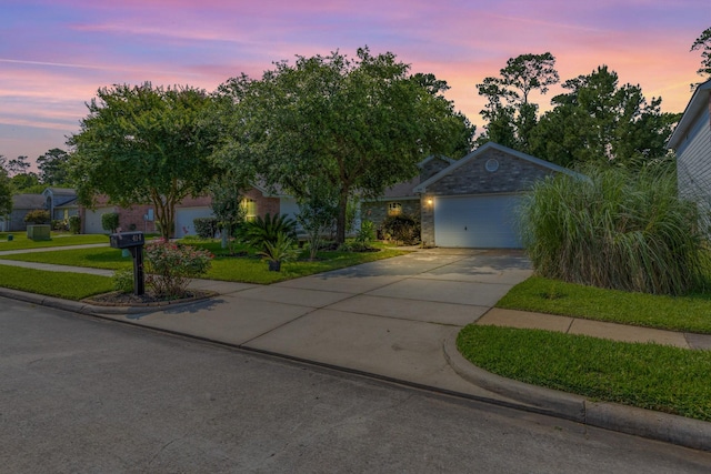 414 Laurel Sage Dr, Houston, TX 77339 - view of property hidden behind natural elements featuring driveway, a lawn, and an attached garage