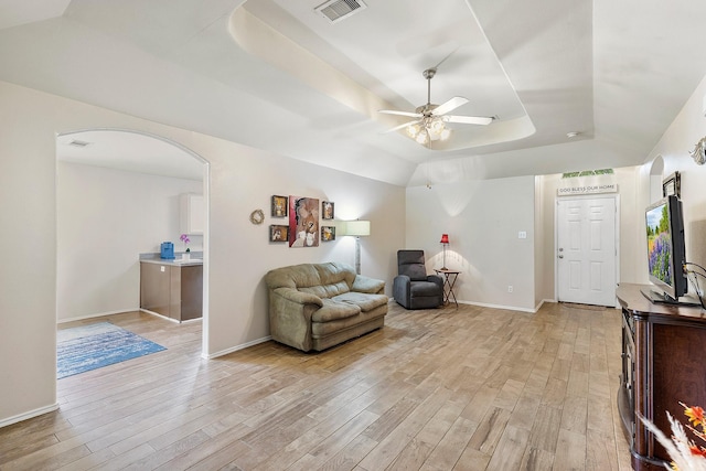 414 Laurel Sage Dr, Houston, TX 77339 - sitting room featuring a raised ceiling, light wood finished floors, a ceiling fan, baseboards, and arched walkways