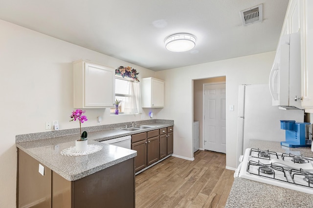 414 Laurel Sage Dr, Houston, TX 77339 - kitchen with light wood-style floors, a sink, range, a peninsula, and light countertops