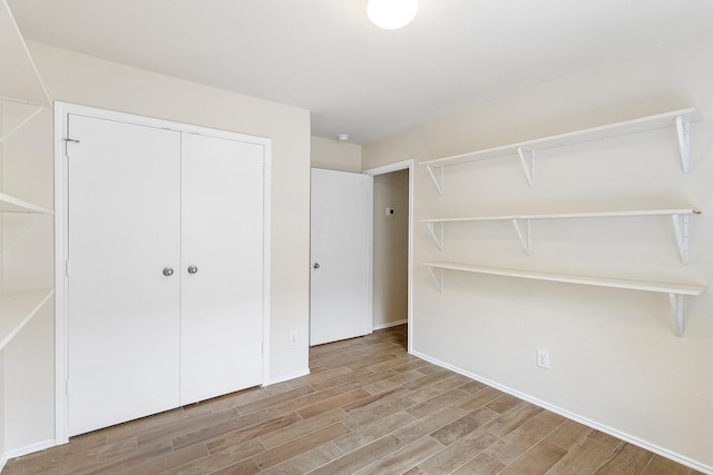 414 Laurel Sage Dr, Houston, TX 77339 - unfurnished bedroom featuring wood finished floors, baseboards, and a closet