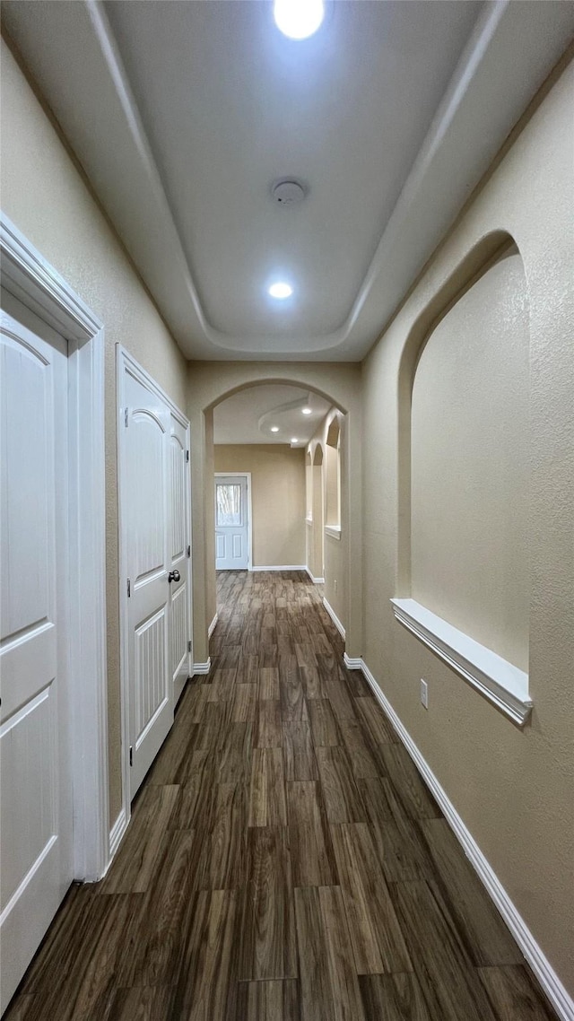 712 Lettie St, Richmond, TX 77469 - corridor featuring arched walkways, dark wood-type flooring, baseboards, and recessed lighting