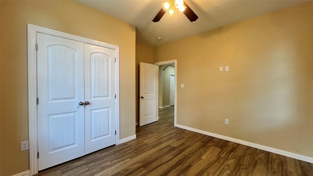 712 Lettie St, Richmond, TX 77469 - unfurnished bedroom featuring baseboards, dark wood-style flooring, a closet, and a ceiling fan