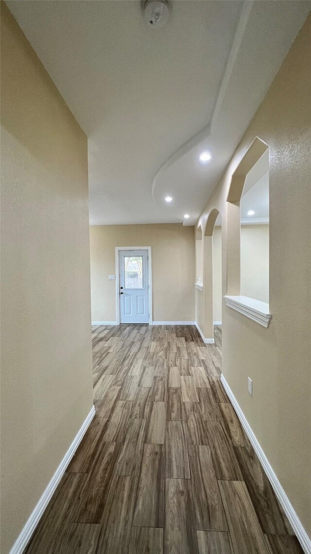 712 Lettie St, Richmond, TX 77469 - corridor featuring baseboards, wood finished floors, arched walkways, and recessed lighting