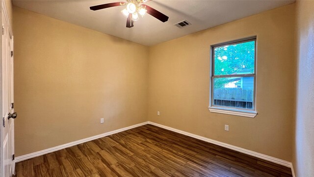 712 Lettie St, Richmond, TX 77469 - empty room featuring dark wood-style flooring, baseboards, and ceiling fan
