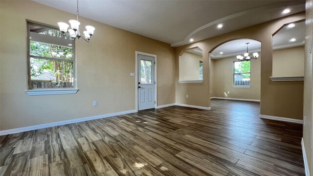 712 Lettie St, Richmond, TX 77469 - empty room featuring a chandelier, wood finished floors, baseboards, arched walkways, and recessed lighting
