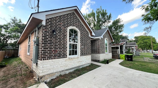 712 Lettie St, Richmond, TX 77469 - view of side of home with brick siding and a patio area