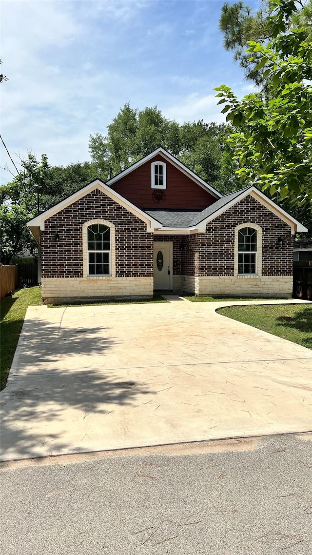 712 Lettie St, Richmond, TX 77469 - view of front of house with a shingled roof and brick siding