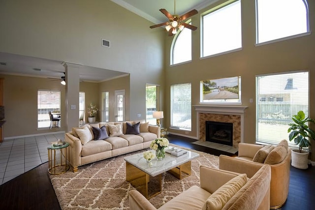 22107 Skyridge Ln, Richmond, TX 77469 - living area featuring ceiling fan, ornamental molding, wood finished floors, a tile fireplace, and a towering ceiling