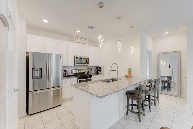 5022 Jonina Ln, Houston, TX 77048 - kitchen with stainless steel appliances, a sink, a kitchen breakfast bar, light tile patterned flooring, and recessed lighting