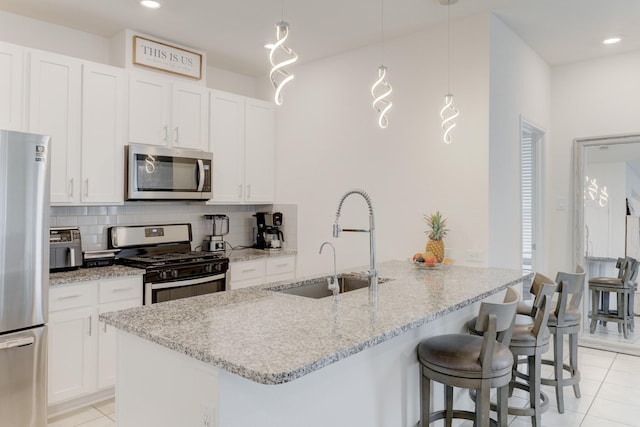5022 Jonina Ln, Houston, TX 77048 - kitchen with appliances with stainless steel finishes, a sink, light tile patterned floors, decorative backsplash, and light stone countertops