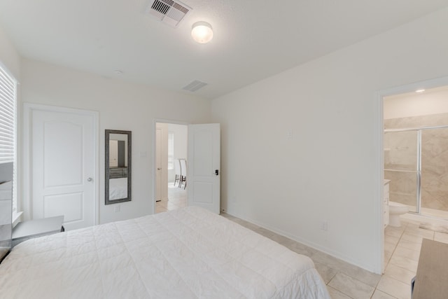 5022 Jonina Ln, Houston, TX 77048 - bedroom featuring light tile patterned floors, connected bathroom, and baseboards