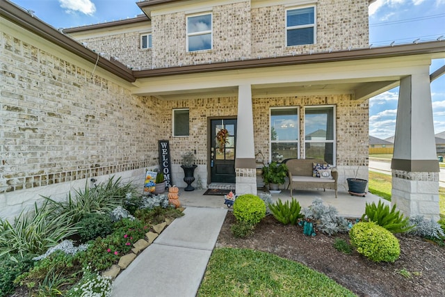 356 Selah Ct, Alvin, TX 77511 - view of exterior entry featuring covered porch and brick siding