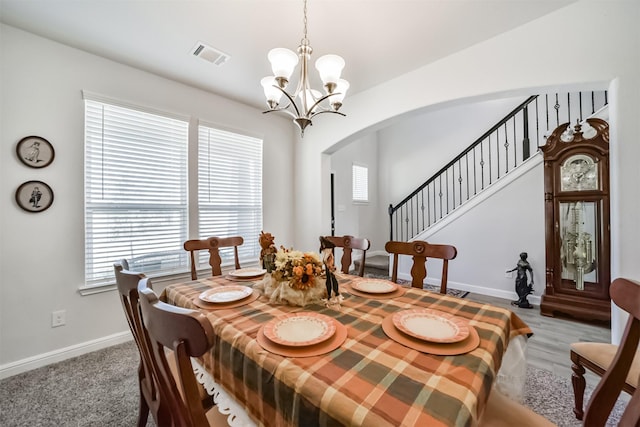 356 Selah Ct, Alvin, TX 77511 - dining room featuring arched walkways, a chandelier, baseboards, and plenty of natural light