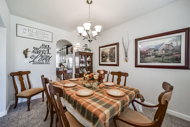 356 Selah Ct, Alvin, TX 77511 - carpeted dining area with arched walkways, a chandelier, and baseboards