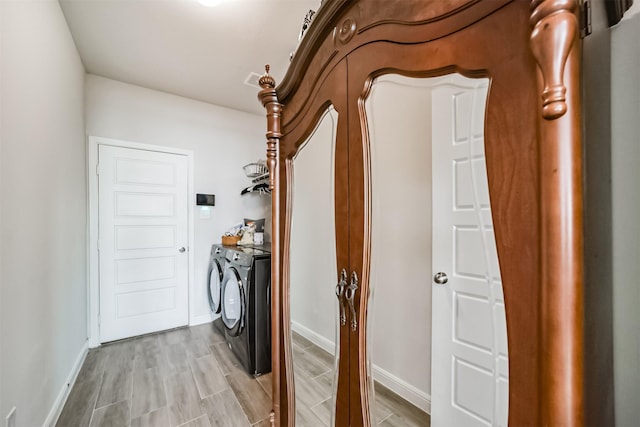 356 Selah Ct, Alvin, TX 77511 - washroom featuring separate washer and dryer, baseboards, and light wood-type flooring