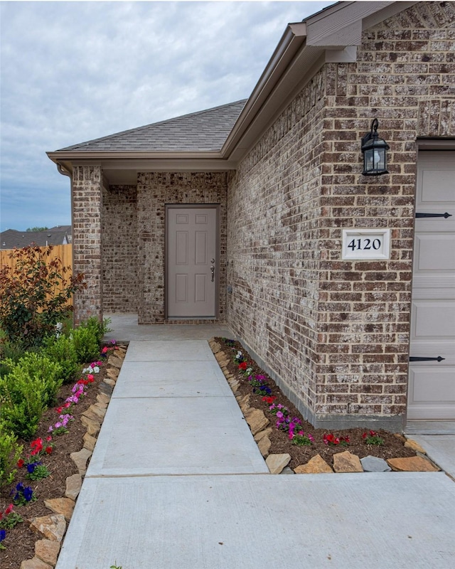 214 Emerald Thicket Ln, Humble, TX 77336 - entrance to property featuring brick siding and a shingled roof