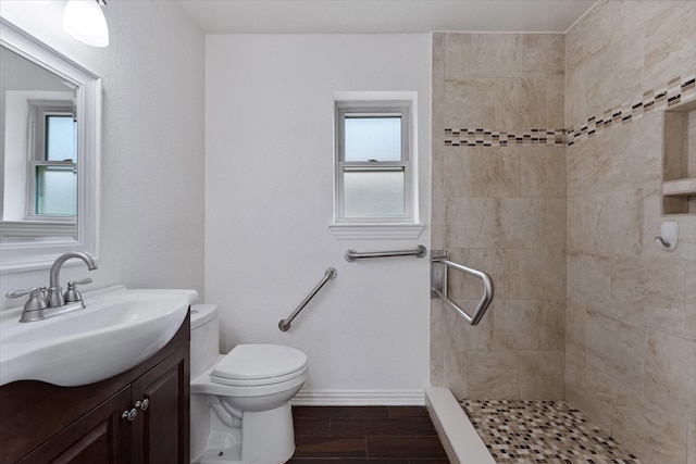 2510 Leichester Dr, Spring, TX 77386 - full bathroom with vanity, a tile shower, toilet, and healthy amount of natural light