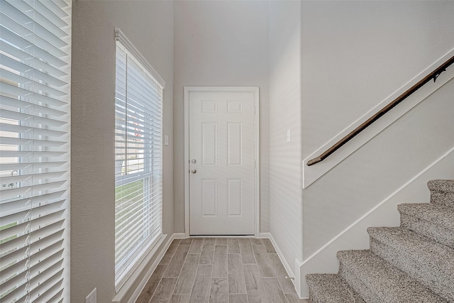 24705 Thornbluff Briar Trl, Huffman, TX 77336 - foyer entrance featuring wood tiled floors, stairway, and baseboards