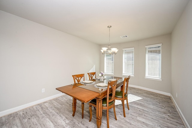 11210 Victoria Hollow Trce, Richmond, TX 77406 - dining room featuring a chandelier, baseboards, and light wood-style flooring