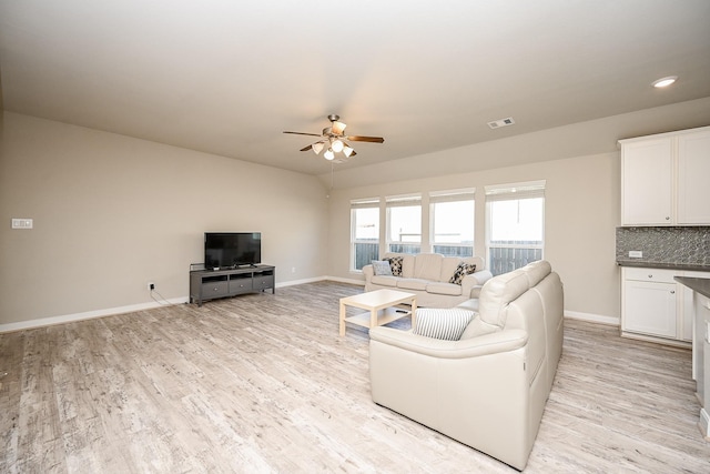 11210 Victoria Hollow Trce, Richmond, TX 77406 - living room featuring ceiling fan, baseboards, and light wood-style floors