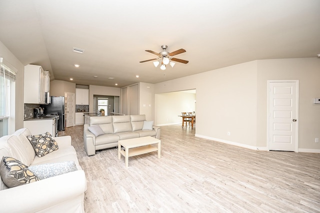 11210 Victoria Hollow Trce, Richmond, TX 77406 - living room with a ceiling fan, light wood finished floors, and baseboards