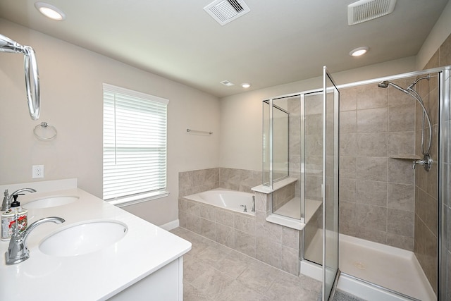11210 Victoria Hollow Trce, Richmond, TX 77406 - bathroom featuring a bath, double vanity, a shower stall, tile patterned floors, and recessed lighting