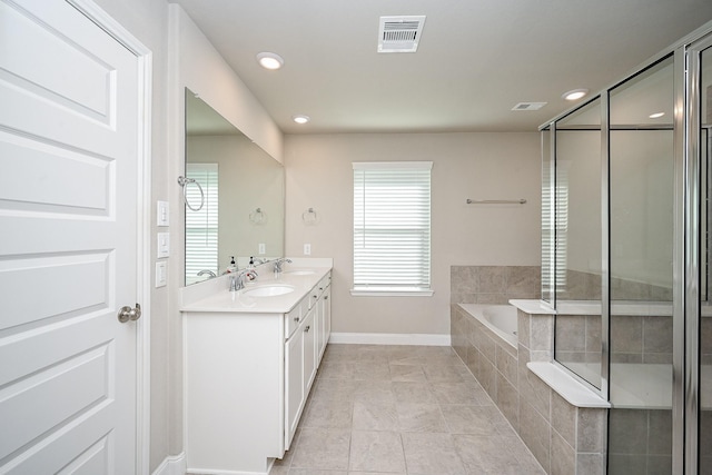 11210 Victoria Hollow Trce, Richmond, TX 77406 - bathroom featuring double vanity, a bath, baseboards, recessed lighting, and tile patterned floors