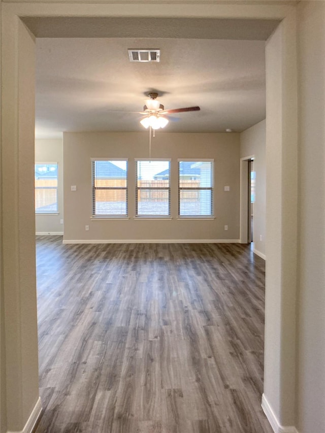 27203 Blue Pool Dr, Katy, TX 77493 - empty room featuring baseboards, a ceiling fan, and dark wood-style flooring