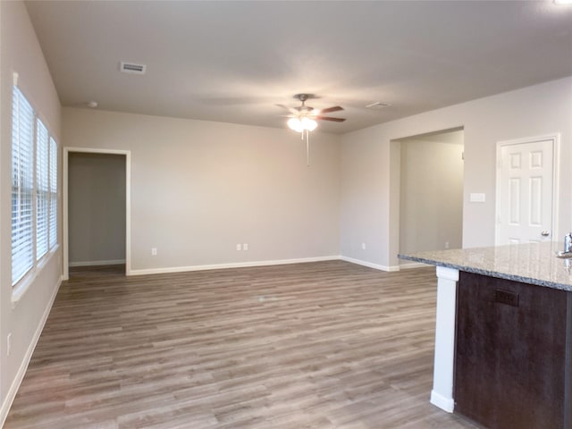 27203 Blue Pool Dr, Katy, TX 77493 - unfurnished living room with ceiling fan, light wood finished floors, and baseboards
