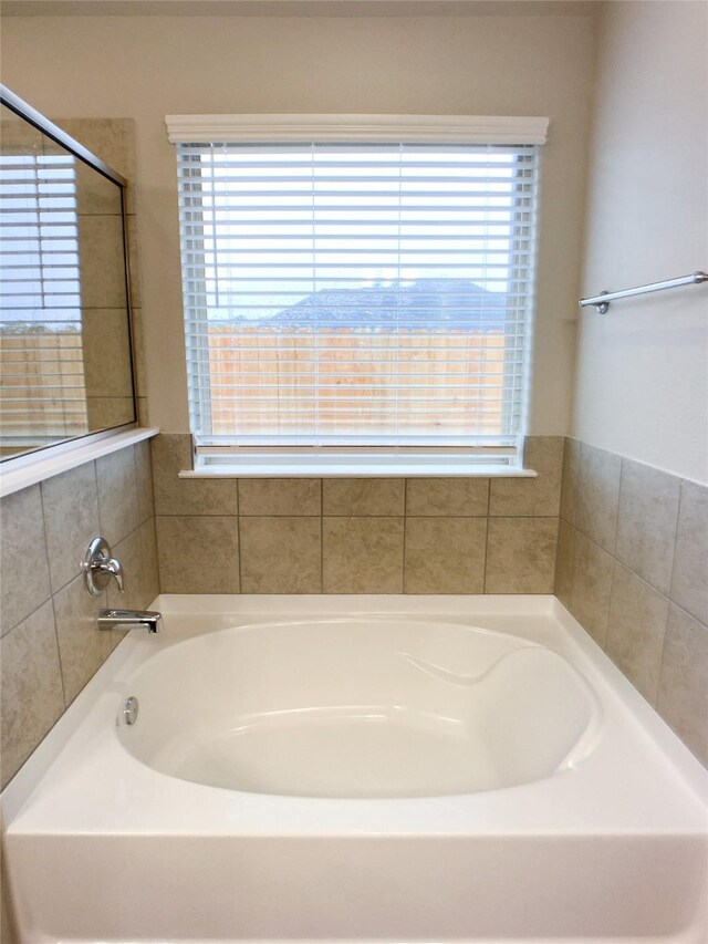 27203 Blue Pool Dr, Katy, TX 77493 - bathroom with a bath and healthy amount of natural light