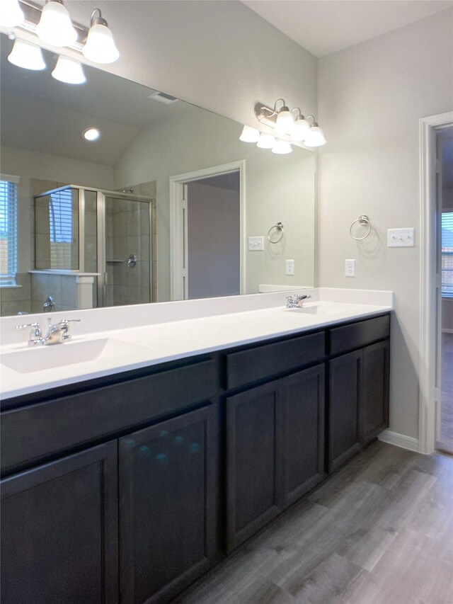 27203 Blue Pool Dr, Katy, TX 77493 - bathroom featuring a chandelier, wood finished floors, double vanity, a shower stall, and lofted ceiling