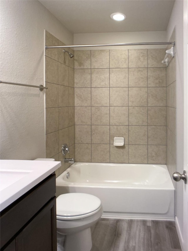 27203 Blue Pool Dr, Katy, TX 77493 - full bathroom with vanity, toilet, wood finished floors, bathtub / shower combination, and a textured wall