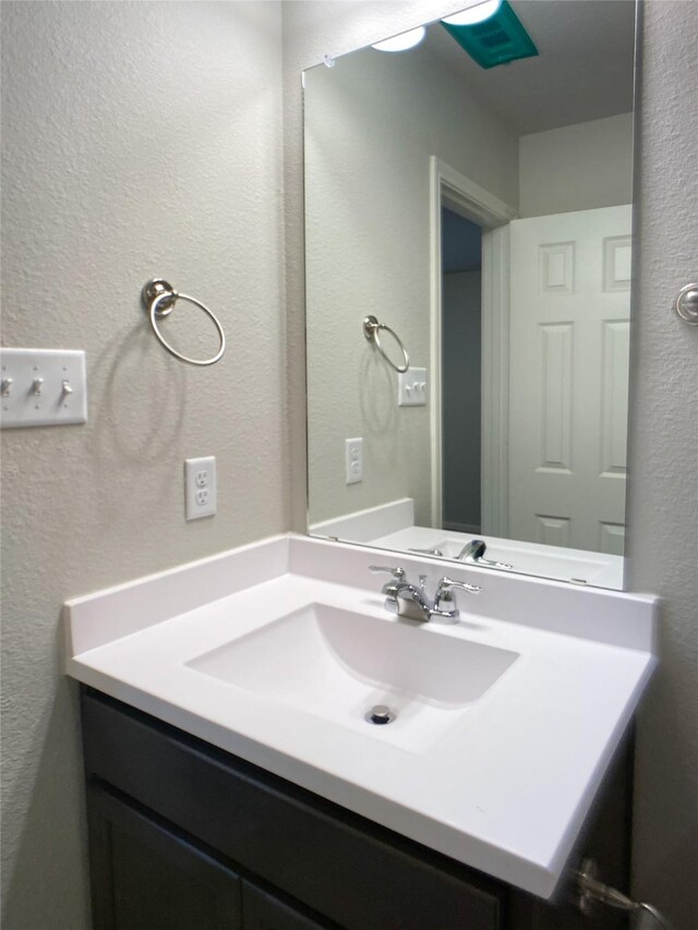 27203 Blue Pool Dr, Katy, TX 77493 - bathroom featuring a textured wall and vanity