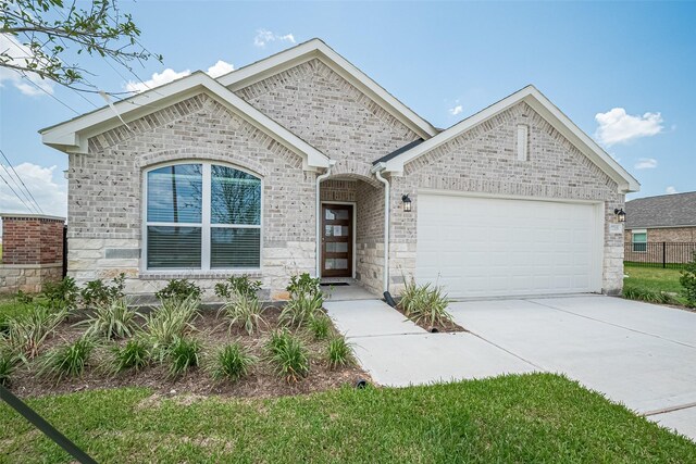 27203 Blue Pool Dr, Katy, TX 77493 - french provincial home featuring an attached garage, concrete driveway, and stone siding