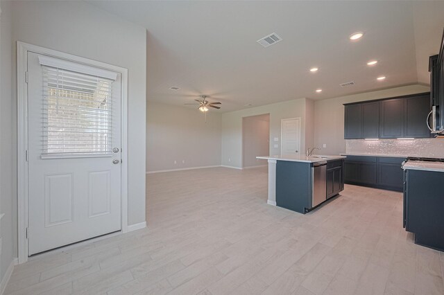 27203 Blue Pool Dr, Katy, TX 77493 - kitchen featuring tasteful backsplash, baseboards, a center island with sink, a ceiling fan, and recessed lighting