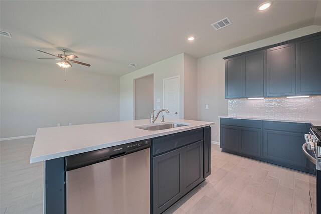 27203 Blue Pool Dr, Katy, TX 77493 - kitchen with appliances with stainless steel finishes, a sink, a ceiling fan, light countertops, and an island with sink