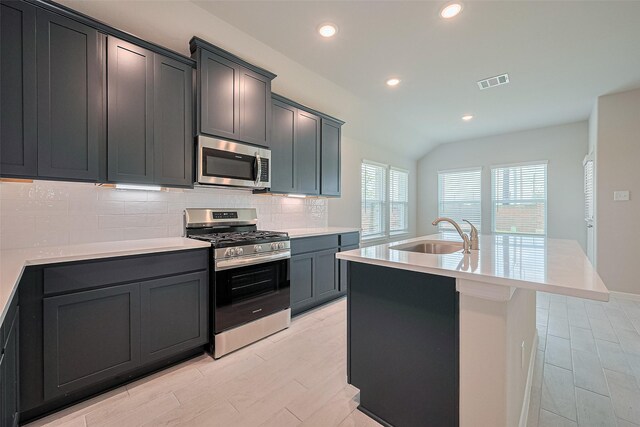 27203 Blue Pool Dr, Katy, TX 77493 - kitchen with appliances with stainless steel finishes, a sink, recessed lighting, backsplash, and lofted ceiling