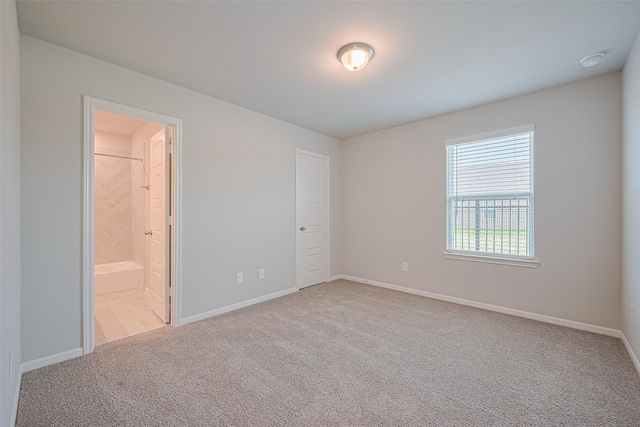 27203 Blue Pool Dr, Katy, TX 77493 - unfurnished bedroom with carpet floors, baseboards, and ensuite bathroom