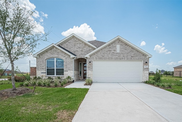 27203 Blue Pool Dr, Katy, TX 77493 - french country home with a garage, concrete driveway, a front lawn, stone siding, and brick siding