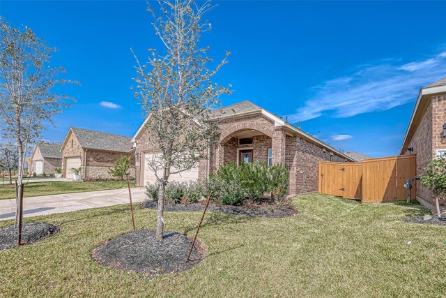 1464 Sundown Glen Ln, Katy, TX 77493 - view of front of home featuring brick siding, driveway, a garage, a front lawn, and roof with shingles