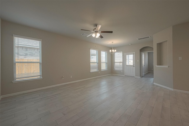 1464 Sundown Glen Ln, Katy, TX 77493 - spare room with a chandelier, a ceiling fan, arched walkways, and light wood finished floors