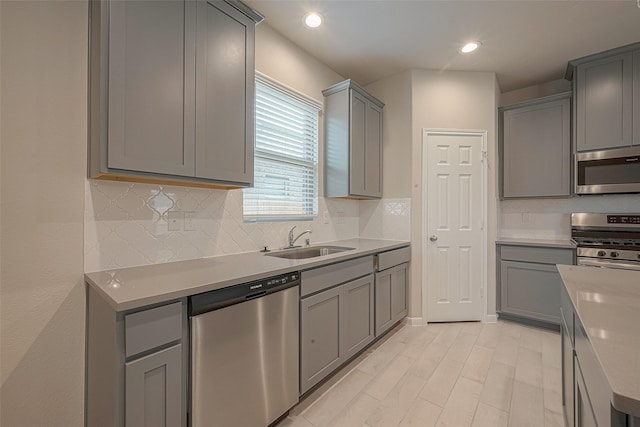 1464 Sundown Glen Ln, Katy, TX 77493 - kitchen with appliances with stainless steel finishes, a sink, gray cabinetry, backsplash, and recessed lighting