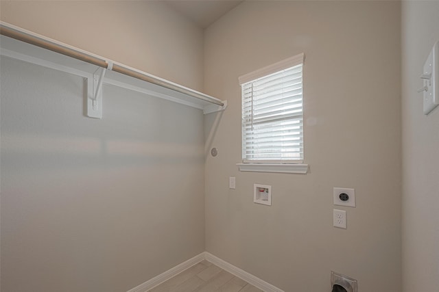 1464 Sundown Glen Ln, Katy, TX 77493 - laundry room with hookup for an electric dryer, washer hookup, baseboards, and light wood finished floors
