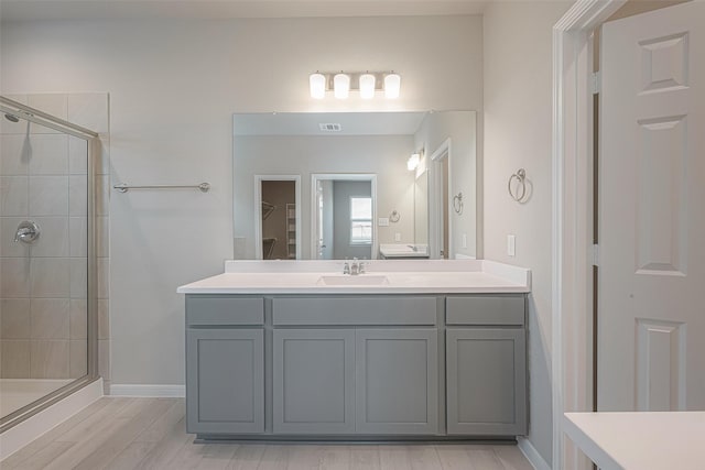 1464 Sundown Glen Ln, Katy, TX 77493 - full bathroom featuring vanity, a shower stall, baseboards, wood finished floors, and a spacious closet