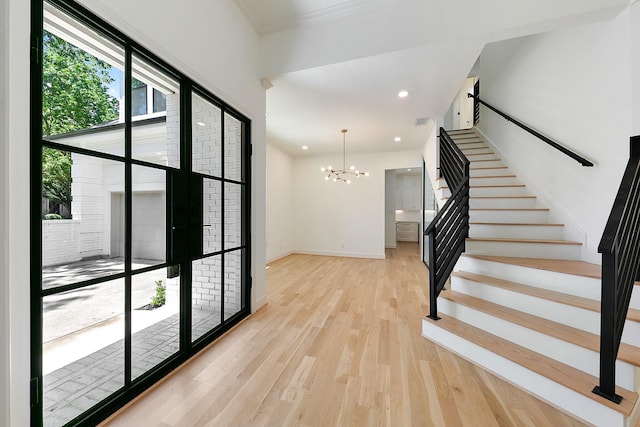 4528 S Evergreen St, Bellaire, TX 77401 - entryway featuring wood finished floors, stairs, a chandelier, crown molding, and baseboards