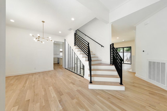 4528 S Evergreen St, Bellaire, TX 77401 - stairway featuring wood finished floors, a chandelier, crown molding, baseboards, and recessed lighting